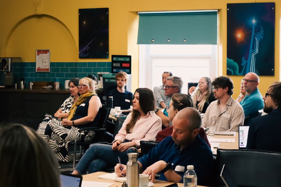 Attendees seated and listening to a presentation during a Somerset Health Determinants Research Collaboration workshop.